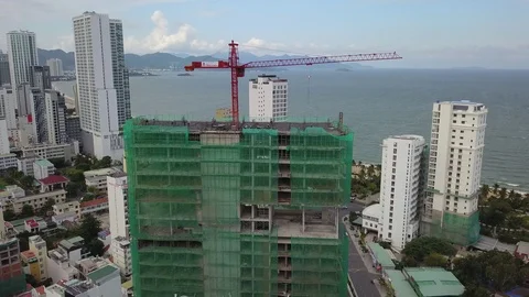 A flying camera takes off a tower crane near a construction Stock Footage 119542484