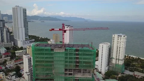 A flying camera takes off a tower crane near a construction Video stock 119543811