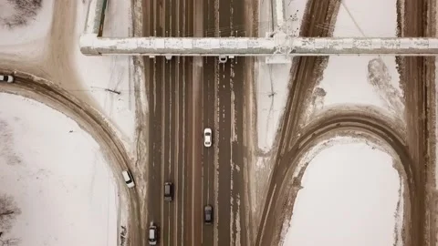 Flying camera from top to bottom shows passing cars on the traffic intersection Video stock 147005437
