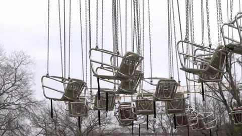 Flying Carousel Chairs swinging in the wind. Closed Fun Park in Austria Stock Footage 231411053