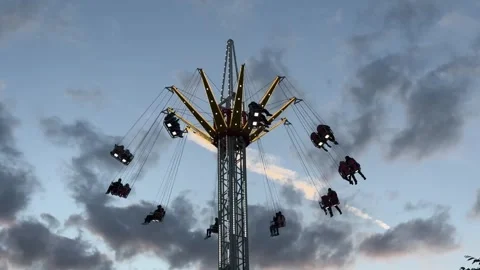 Flying carousel at sunset in amusement park Stock Footage 310838190