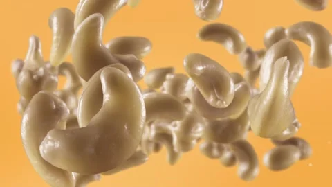 Flying of Cashews in Pale Orange Background Stock Footage 146262028