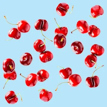 Flying cherries vertical isolated as package design elements. Fresh raw cheery Stock Photos