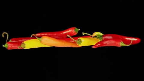 Flying chili infront of black background in slowmotion Stock Footage 163216608