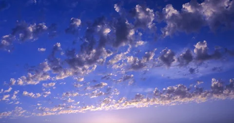 Flying cirrus clouds at sunset against a blue sky Stock Footage 194099128