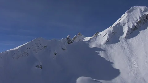 Flying close over mountains opening up a valley Stock Footage 101898671