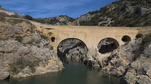 Flying close over water, panning up to Pont Du Diable bridges Stock Footage 102520187