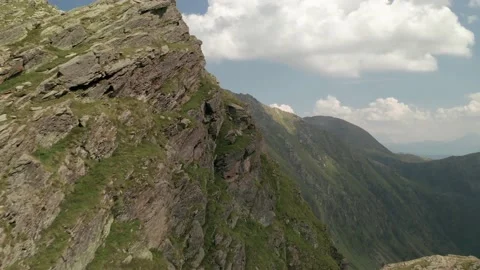 Flying close to rocky mountain wall revealing the valley in Stoandlaberg Stock Footage 229621679