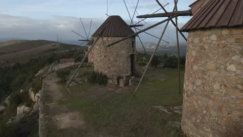 Flying close to several windmills on the top of the mountain Stock Footage 220379068