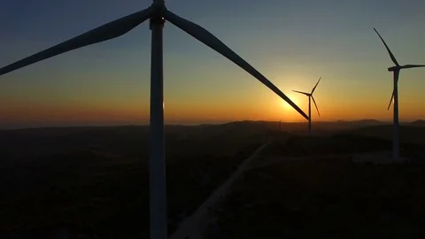 Flying close to windmill blades at dusk Stock Footage 72943880