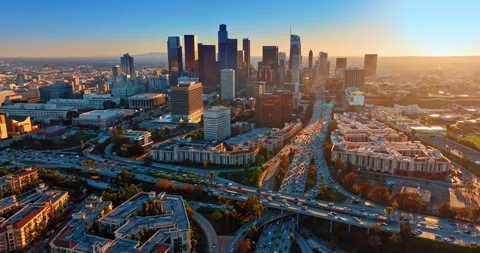 Flying closer to the lively interchange and highways in the cityscape of Los Stock Footage 328429684