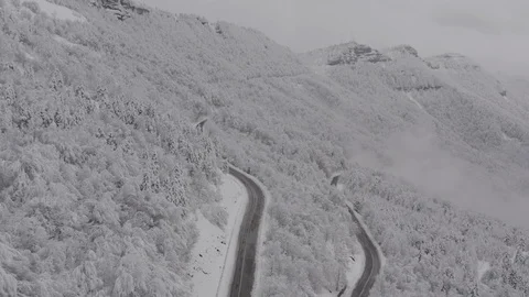 Flying in the clouds above snowy mountain, Georgia (country) Video stock 124928943