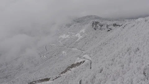 Flying in the clouds above snowy mountain, Georgia (country) Video stock 124932761