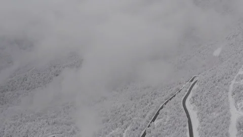 Flying in the clouds above snowy mountain, Georgia (country) Video stock 124934812
