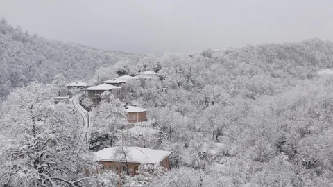 Flying in the clouds above snowy town, Georgia (country) Video stock 124938583