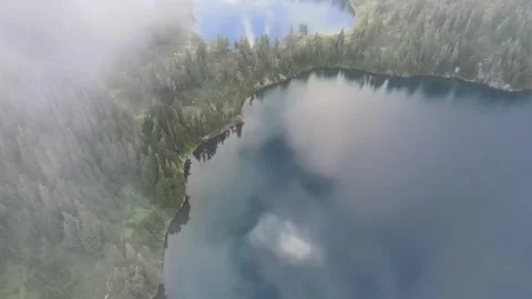 Flying in the clouds above three lakes 스톡 동영상 331960747