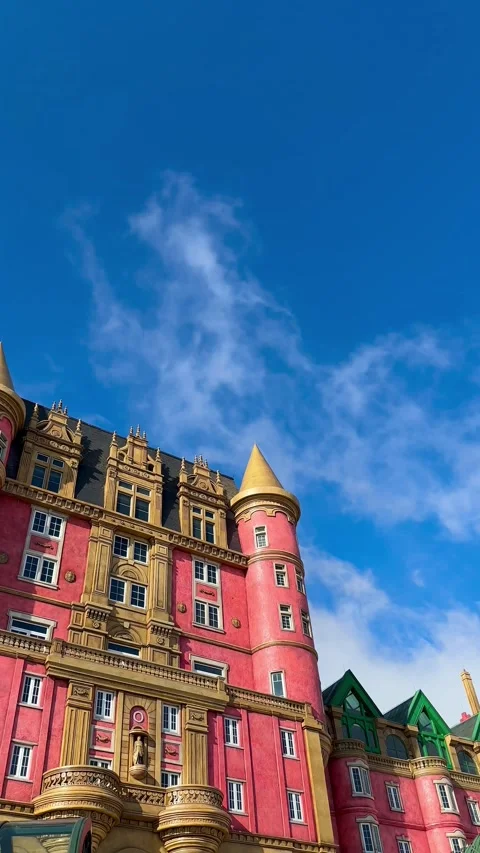 Flying clouds against the background of a bright pink castle under a shining Stock-Footage 302265297