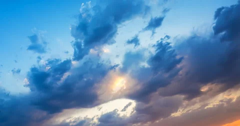 Flying clouds against the setting rays of the sun Stock Footage 115240076