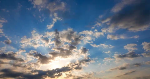 Flying clouds against the setting rays of the sun Stock Footage 115240289