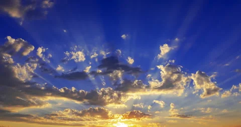 Flying clouds against the setting rays of the sun Stock Footage 203948453