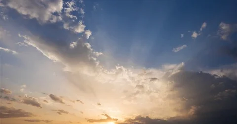 Flying clouds and sunrays at sunset Video stock 80018454