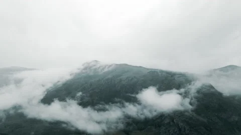 Flying in the clouds to the mountain during light rain Stock Footage 165966855