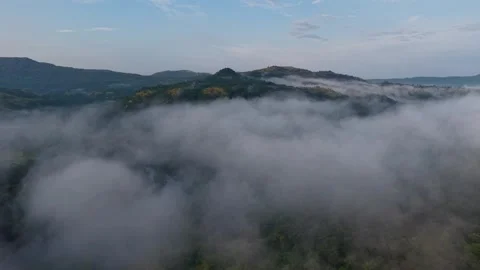 Flying in clouds over savitri river backwaters, Poladpur, Maharashtra, India 動画素材 320555280