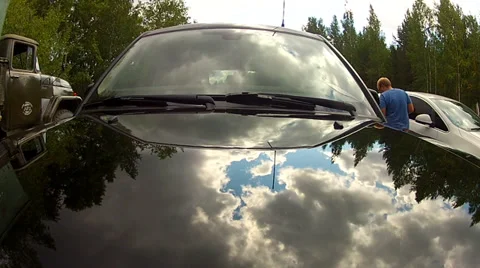 Flying clouds reflected in the back of a car. Timelapse Stock Footage 37875982
