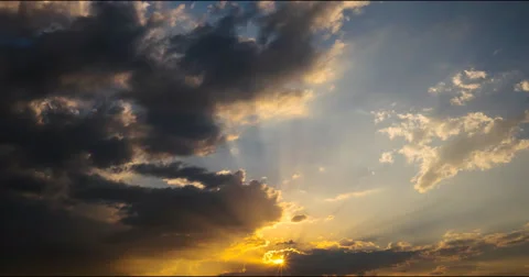 Flying clouds at sunset and  rays of the setting sun Stock Footage 68955319