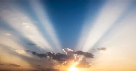 Flying clouds at sunset and  rays of the setting sun Stock Footage 68955487