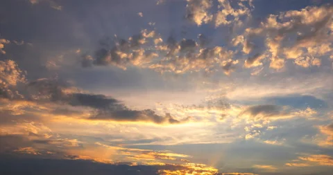 Flying clouds at sunset, illuminated by the rays of the setting sun Stock Footage 92576363