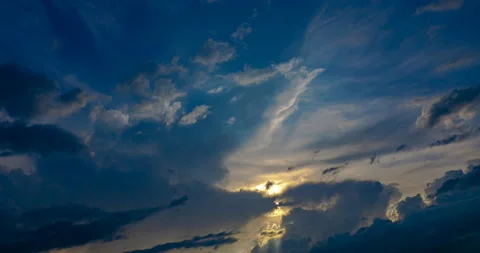 Flying clouds at sunset of them the rays of the setting sun Stock Footage 155799442