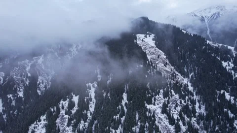 Flying in the clouds with view of snowy mountains Stock Footage 226333897