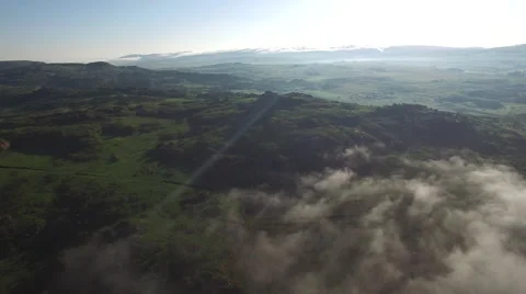 Flying By Cloudy Mountain Peak at Sunrise Stock Footage 65179210