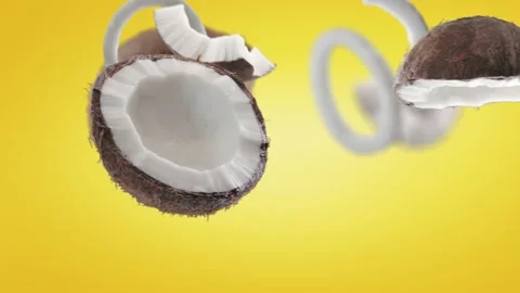 Flying Coconut and Coconuts slices in Yellow Background Video stock 229560977