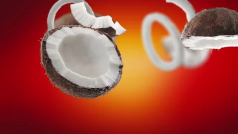 Flying Coconut and Coconuts slices in Red Background Video stock 229561744