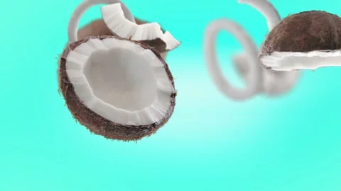 Flying Coconut and Coconuts slices in Ice Blue, Turquoise Background Stock Footage 229562497
