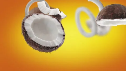 Flying Coconut and Coconuts slices in Orange Background Stock Footage 229563519