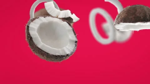 Flying Coconut and Coconuts slices in Fuchsia Pink Background Stock Footage 229564542
