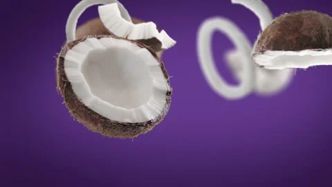 Flying Coconut and Coconuts slices in Violet Purple Background Stock Footage 229565362