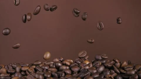 Flying coffee beans on a brown background. Super slow-motion. Stock Footage 150148540