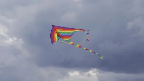 A flying colored kite against the blue sky sways in the wind Stock-Footage 251293210