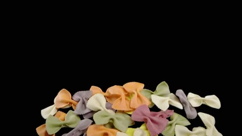 Flying colored pasta on a black background. Super slow-motion. Видео 149326967