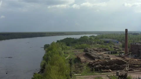 Flying a copter over a logging plant. Hundreds of log cabins lie on the ground Stock Footage 155183938