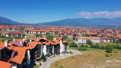 Flying copter over the red roofs rural town in mountains Stock Footage 114685830