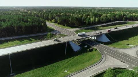 Flying a copter over a road junction. Trucks and cars are driving along the Stock-Footage 140110385