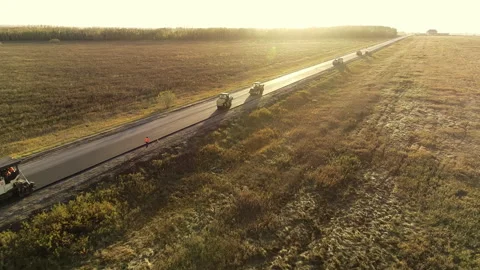 Flying a copter over the track with road construction equipment. Road repair Stock Footage 138669416