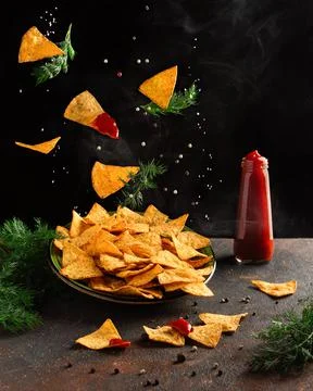 Flying corn chips with pepper and salt. Levitation Stock Photos