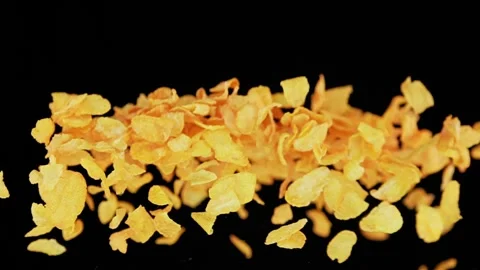 Flying cornflakes infront of black background in slowmotion Stock Footage 163216415