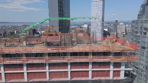 Flying counter clock around crane atop skyscraper under construction in Brooklyn Stock Footage 247083377